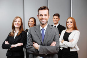 group of business man and women smiling at a camera