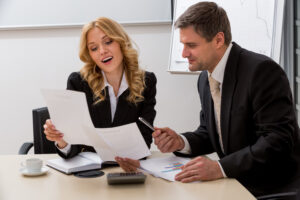 business man and woman looking at papers together