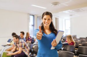 woman in lecture hall putting her thumb up