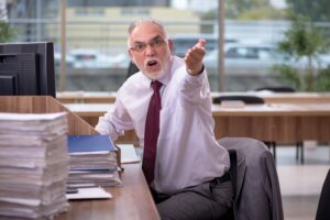 business man shouting and pointing his hand at camera