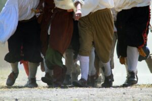 a lot of mens legs in medieval clothes (costumes)